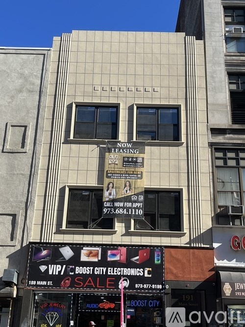 A building with a sign that says "Now Leasing" and a phone number below it.