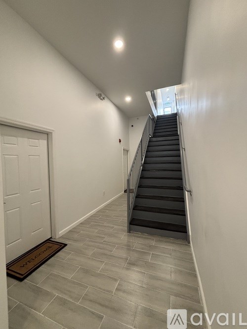 A white toilet sits next to a walk-in shower in a bathroom.