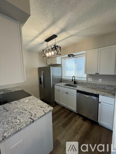 A kitchen with granite countertops and stainless steel appliances.