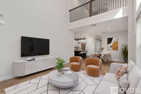 A living room with a white sofa, a black TV, and a coffee table with a plant on it.