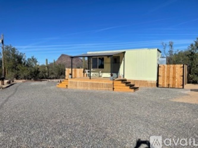 A house with a gravel driveway in front of it.