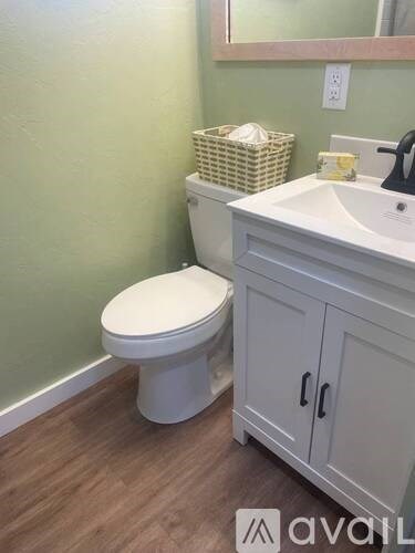 A white toilet sits next to a sink in a bathroom.