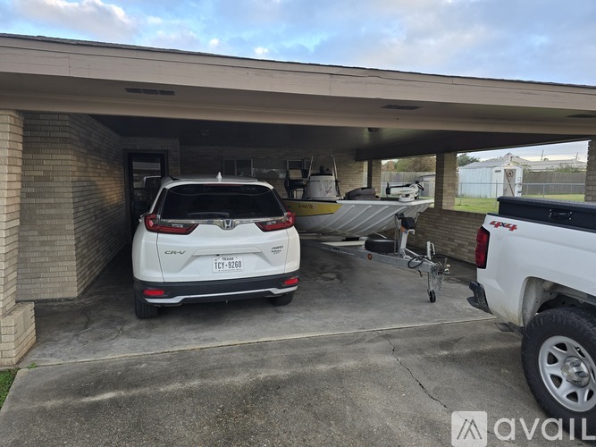 A white Honda SUV is parked in a garage.