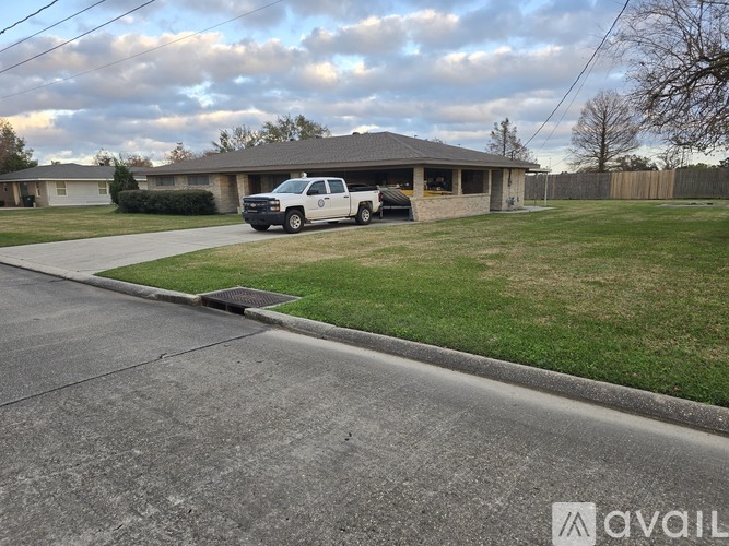 A house with a white truck parked in front.