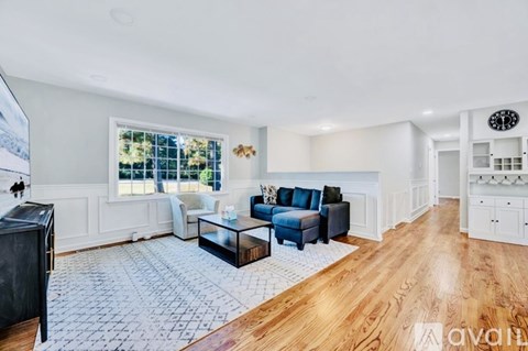 A living room with a black coffee table and blue couches.