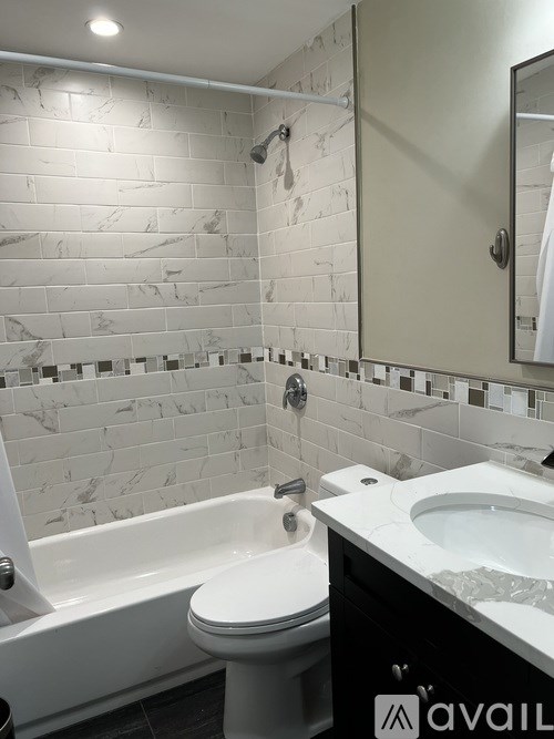 A bathroom with a white toilet, a white sink, and a white bathtub.