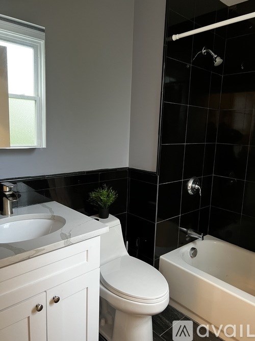 A white toilet sits next to a sink in a bathroom.