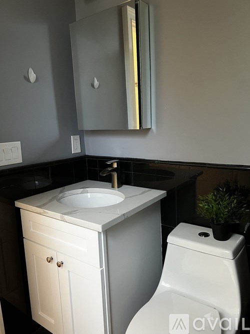 A white sink and toilet in a bathroom.