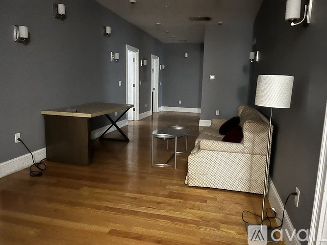 A living room with a couch, chair, and table.