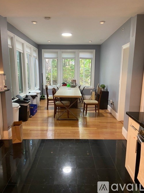 A kitchen with a table and chairs in the middle of the room.