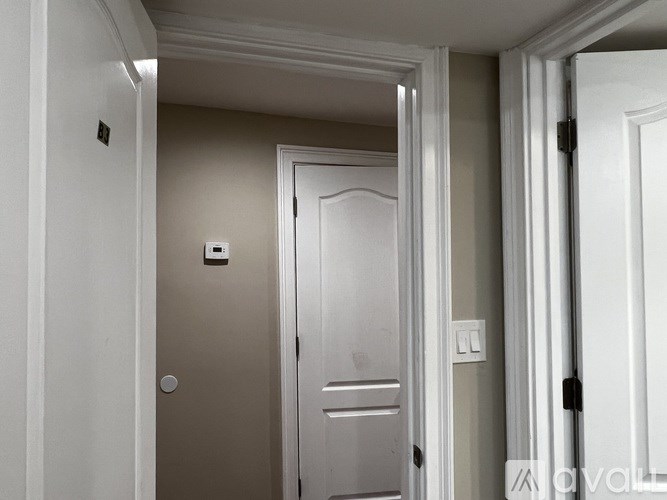 A white door is open to a hallway.