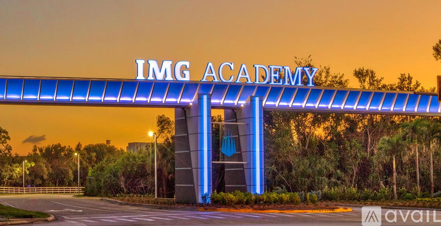 The entrance to the IMG Academy is lit up with blue lights.