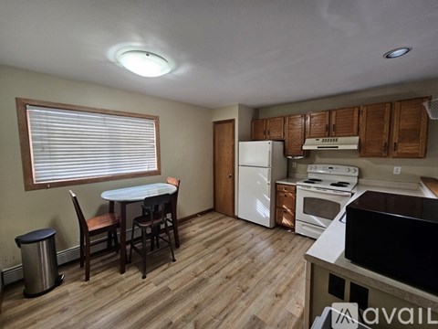 A kitchen with a white refrigerator, oven, and stove.