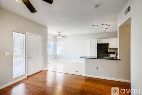 A spacious living room with a television and a bar area.