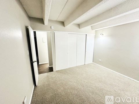 A room with a carpeted floor and white walls.