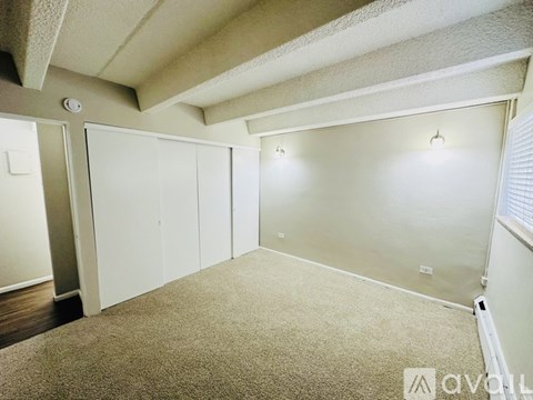 A room with carpeted floor and white walls.