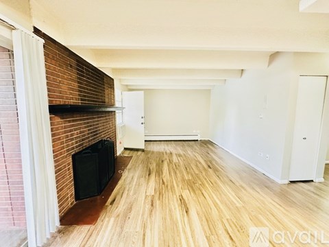 A living room with a fireplace and a flat screen TV.
