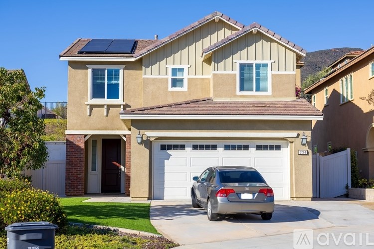A house with a car parked in front of it.
