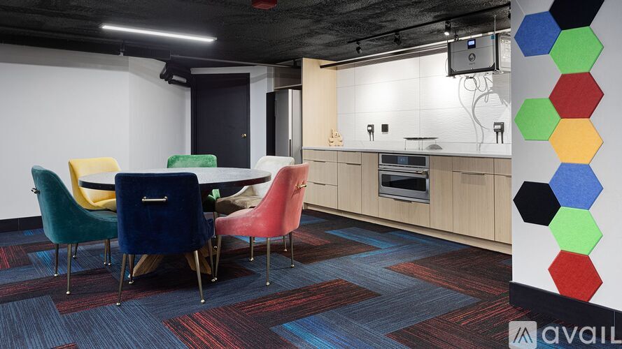 A modern kitchen with a dining table and chairs.