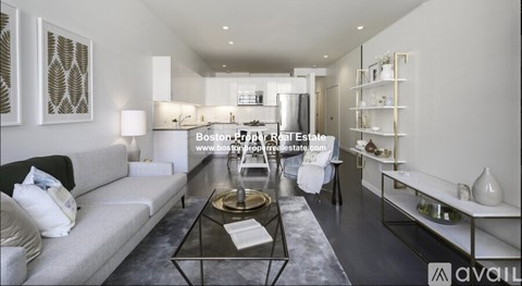 A modern living room with a glass coffee table and a white sofa.