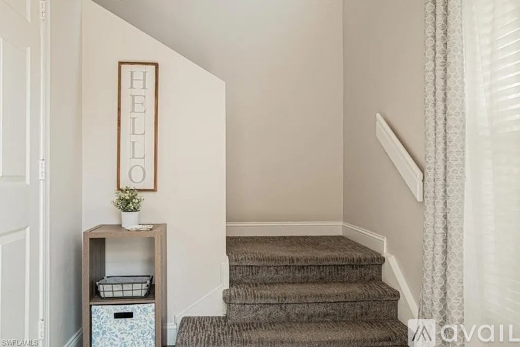 A staircase with a carpeted runner and a wooden banister.