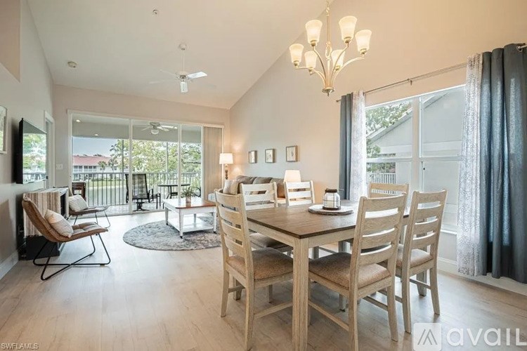 A dining room with a wooden table and chairs.