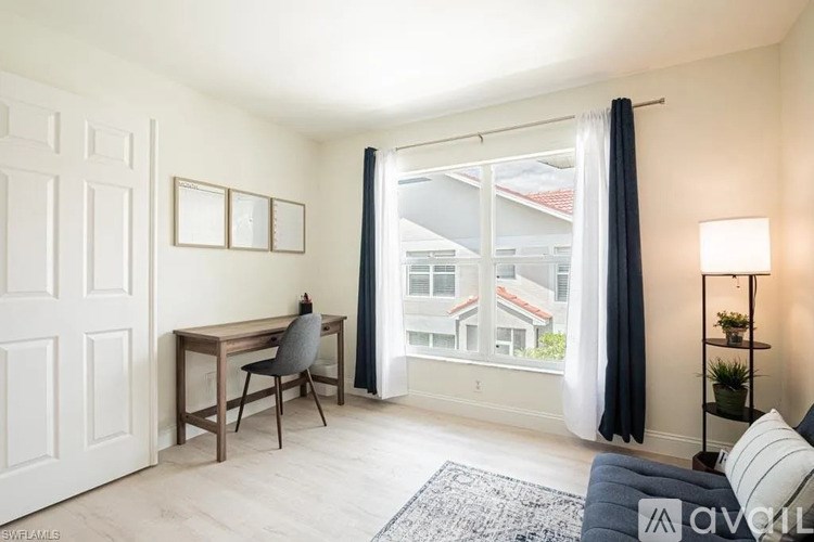 A room with a desk and chair in it.