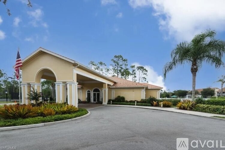 A building with a flag on the left and a palm tree on the right.