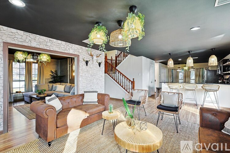 A living room with a brown leather couch and a wooden coffee table.