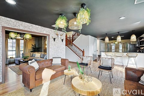 A living room with a brown leather couch and a wooden coffee table.
