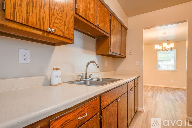 A kitchen with wooden cabinets and a sink.