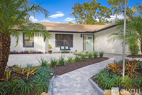 A house with a garden in front of it.