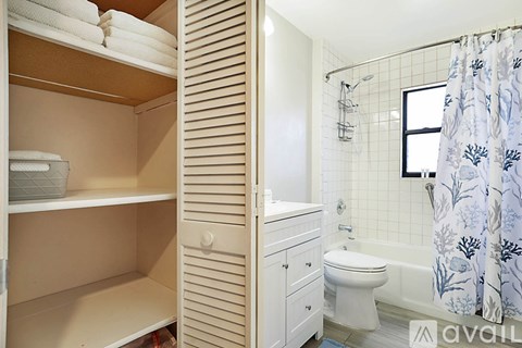 A bathroom with a toilet, sink, and shower.