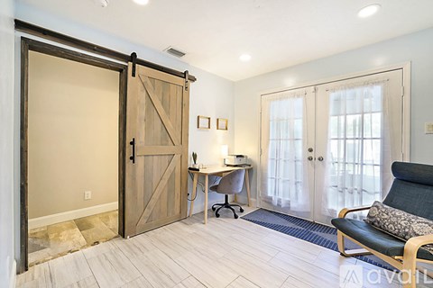 A room with a wooden floor and a sliding door.