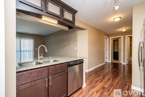 A kitchen with wooden cabinets and a granite countertop.