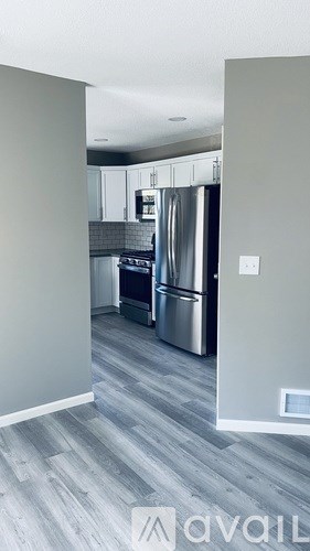 A kitchen with a stainless steel refrigerator and oven.