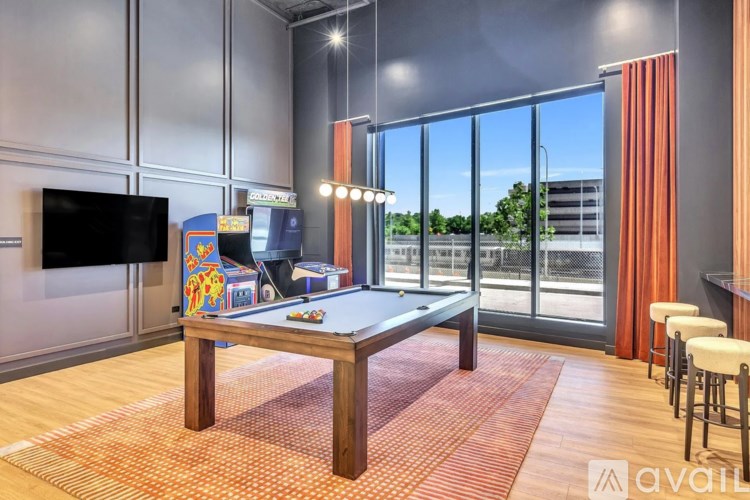 A room with a pool table and a television.