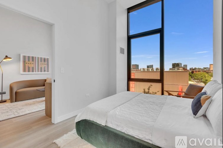 A bedroom with a large bed and a view of the city.