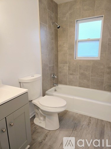 A bathroom with a toilet, sink, and tub.