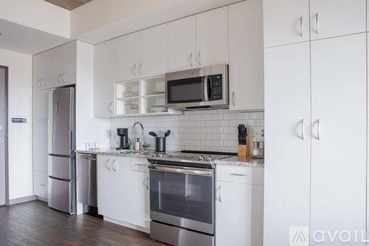 A kitchen with white cabinets and stainless steel appliances.