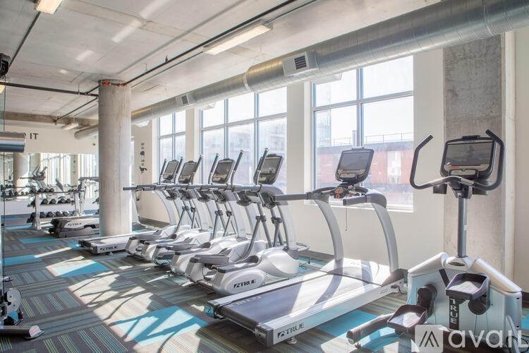 A gym with treadmills and a sign that says "FIT".
