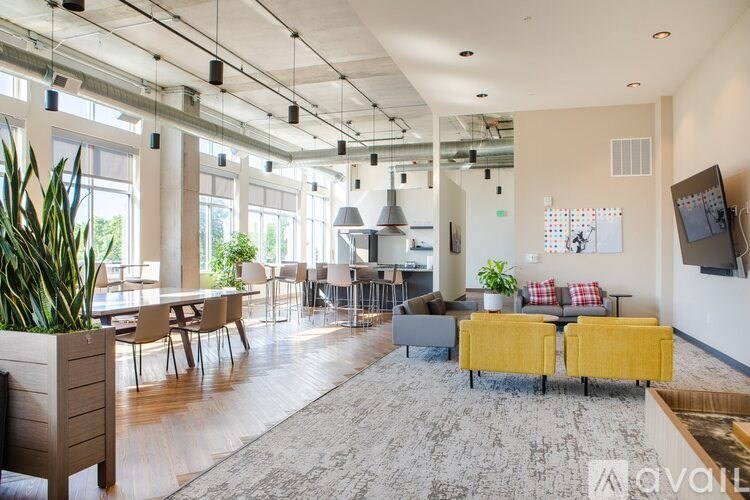 A modern open plan office space with a variety of seating options and natural light.