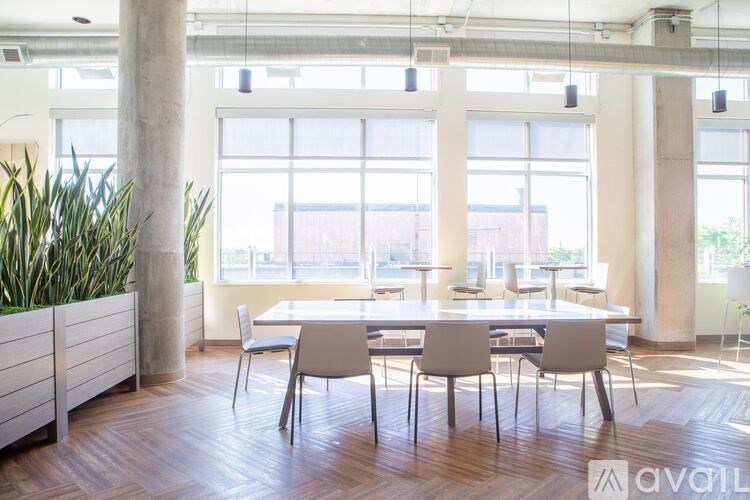A conference room with a long table and chairs.