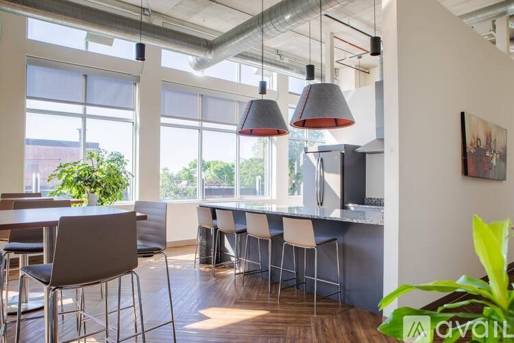 A modern kitchen with a dining table and chairs.