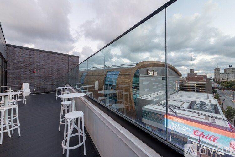 A glass barrier separates the interior of a building from a Chill Iguazu advertisement.