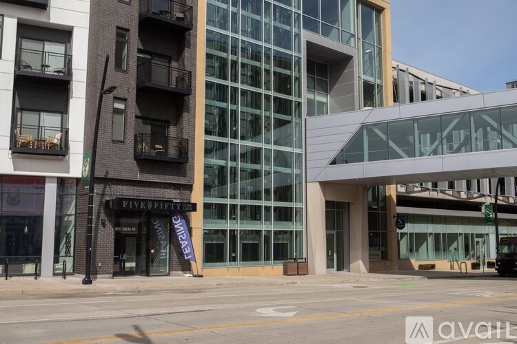 A building with a glass facade and a sign that says "Five Fifty".