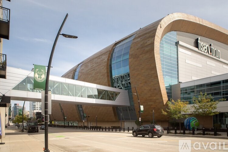A modern building with a curved wooden facade and glass windows.