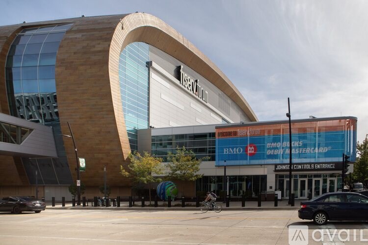 A modern building with a curved glass facade and a sign that reads "Tesco".