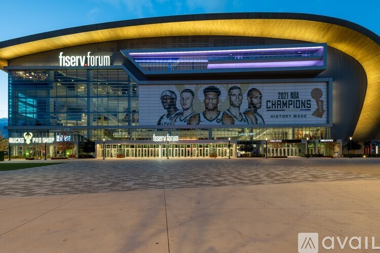 A large building with a banner that reads "2021 NBA CHAMPIONS HISTORY MADE".