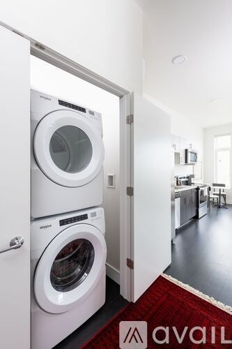A white washing machine and dryer in a small laundry room.